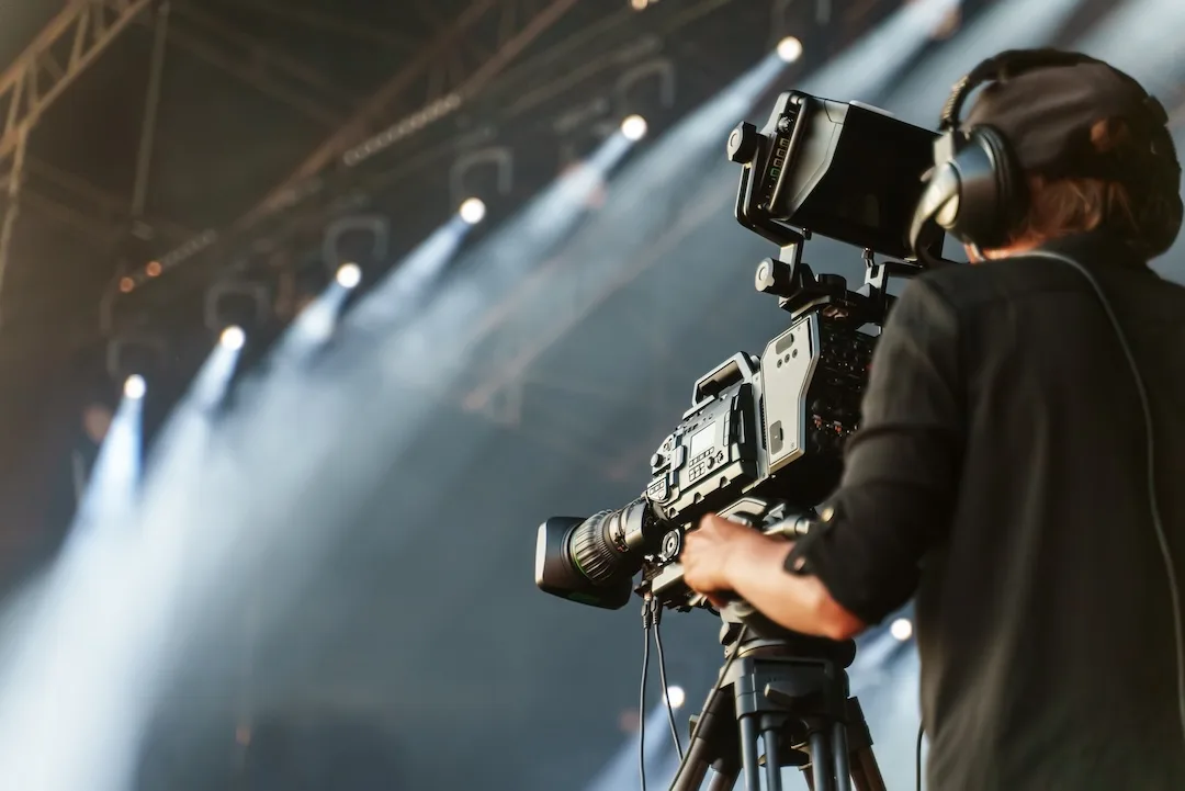Cinematographer operating a professional camera at a live production
