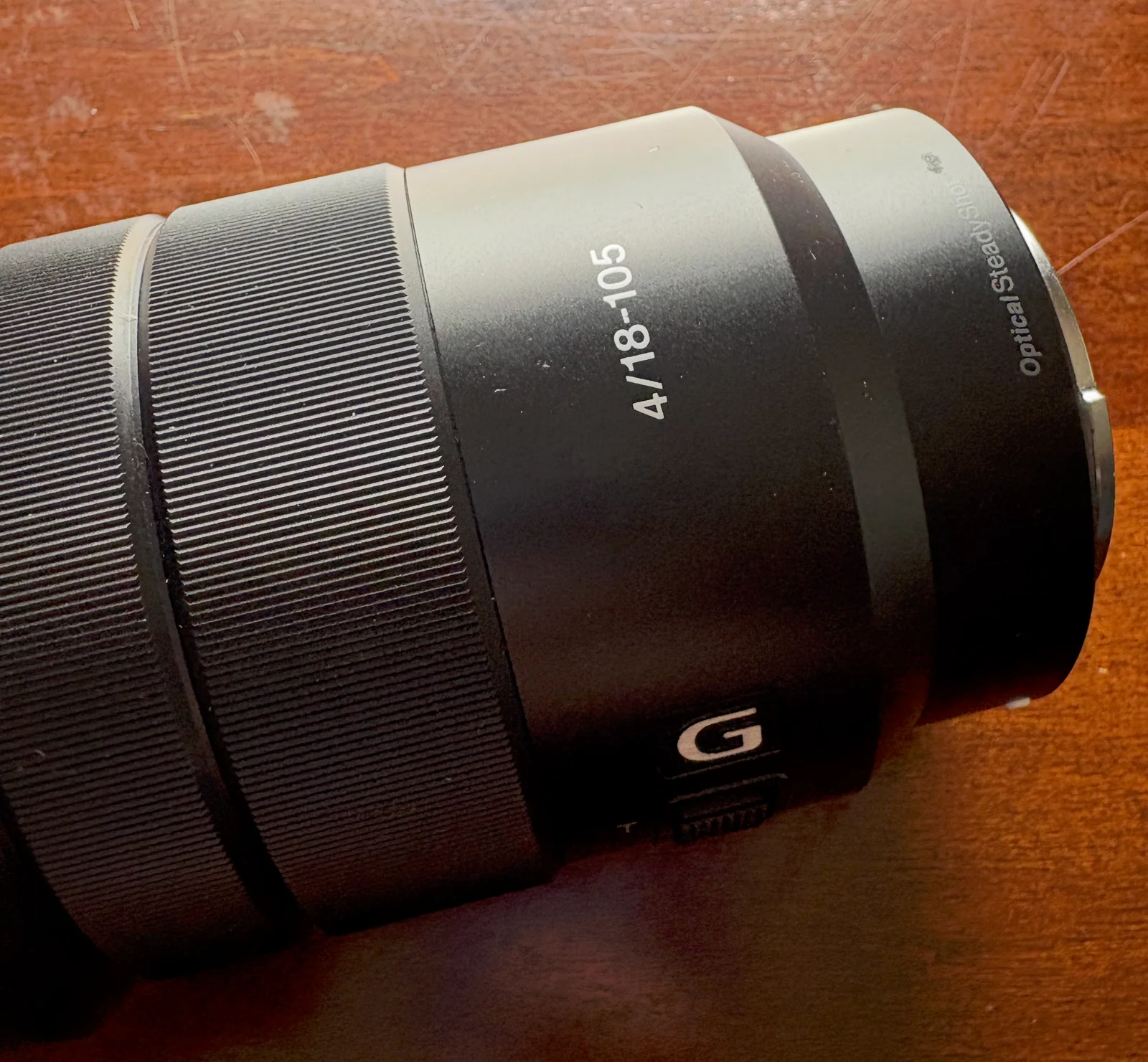 Sony 18–105mm f/4 G zoom lens on a wooden counter.