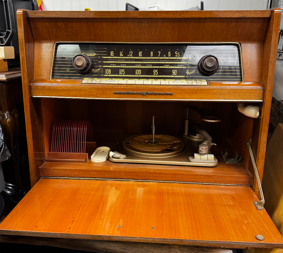 Wooden vintage radio cabinet with an open record-player compartment.